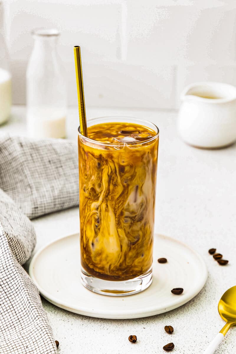 iced caramel latte in tall clear glass with straw