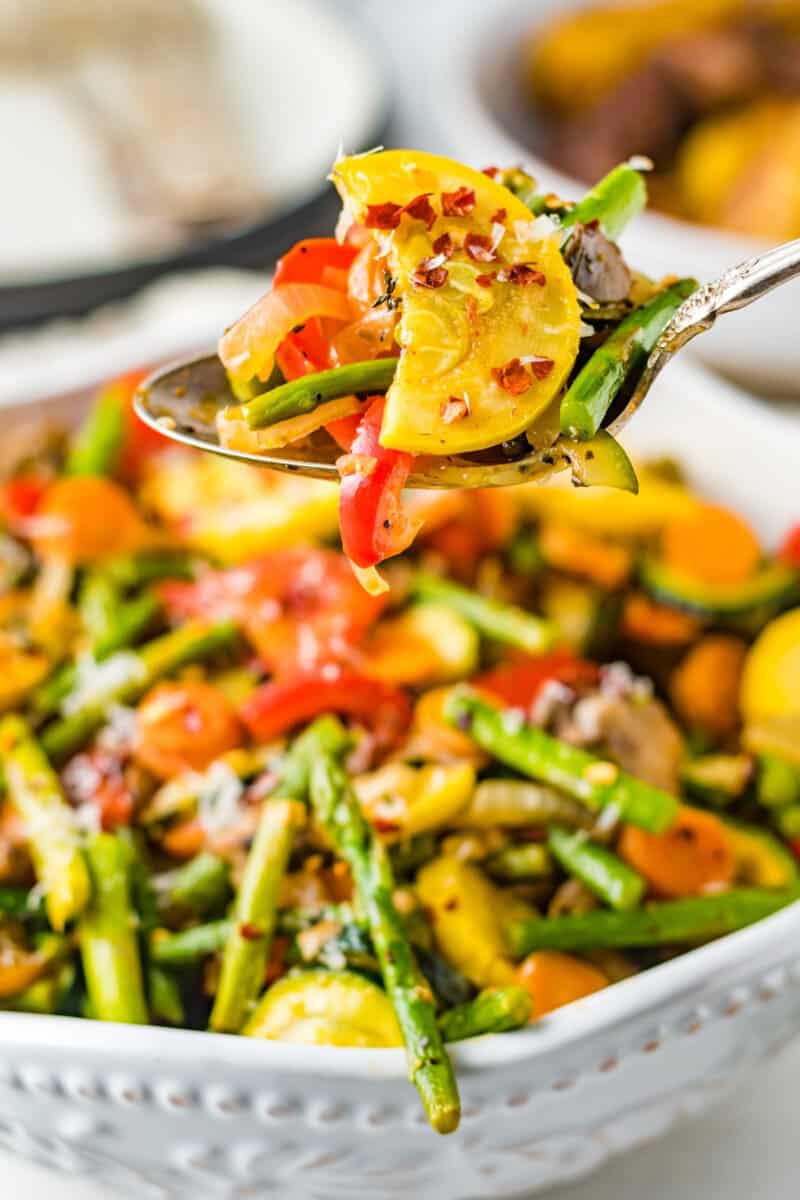 spoon with sauteed vegetables on it